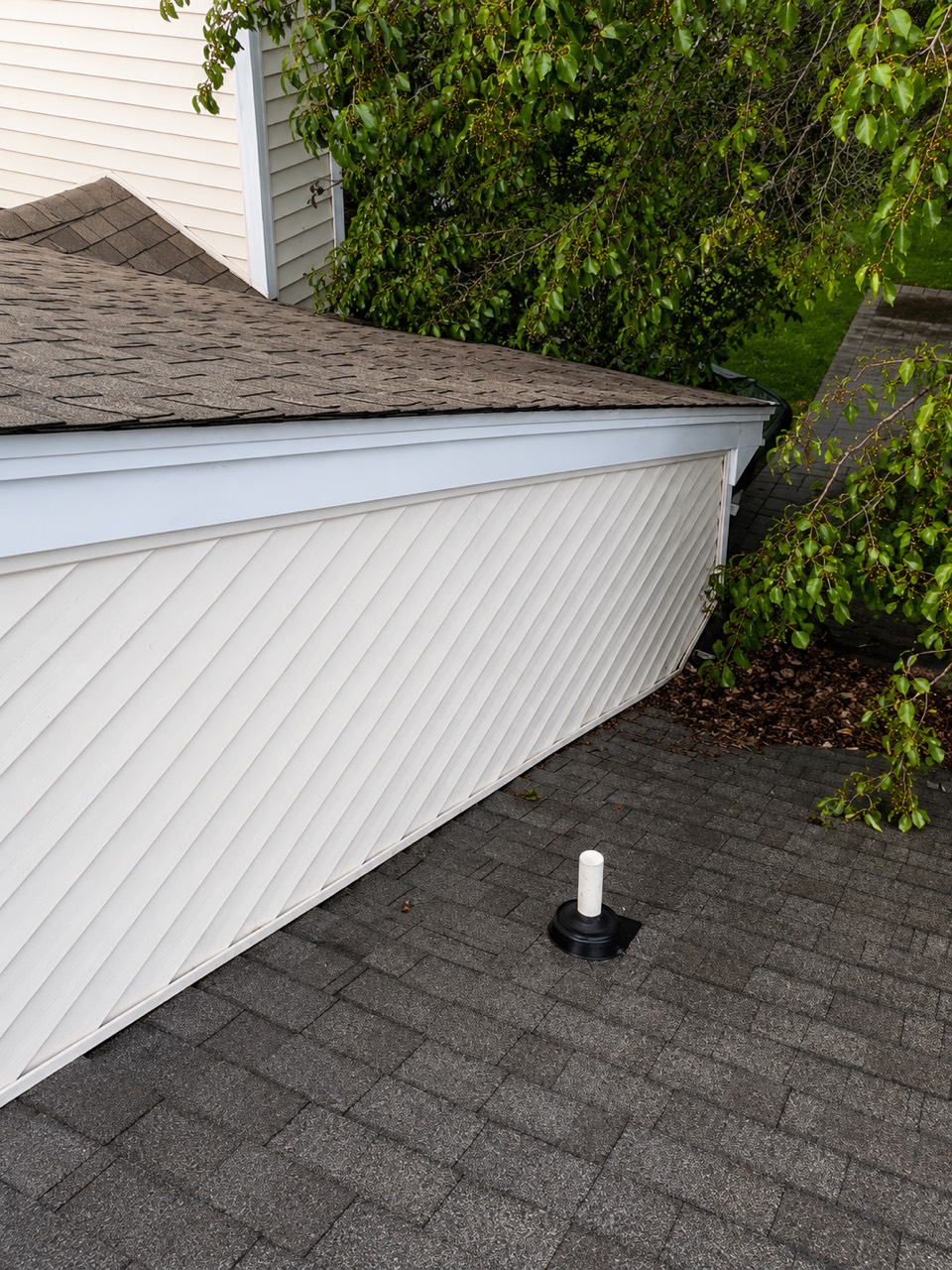 The same siding beside a roofline after house washing